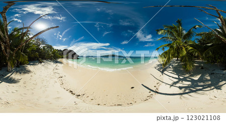 A serene beach lined with swaying palm trees offers cool shade, while gentle waves lap at the pristine shoreline. La Digue, Seychelles. 360 panorama VR. A serene beach lined with swaying palm trees offers cool shade, while gentle waves lap at the pristine shoreline. La Digue, Seychelles. 360 panorama VR. 123021108