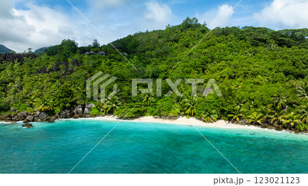 Coastline surrounded by lush vegetation and white sandy beach. Seychelles, Mahe. Butzel Beach. 123021123
