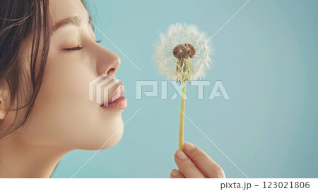Young female with dandelion park blowing love care inspiring 123021806