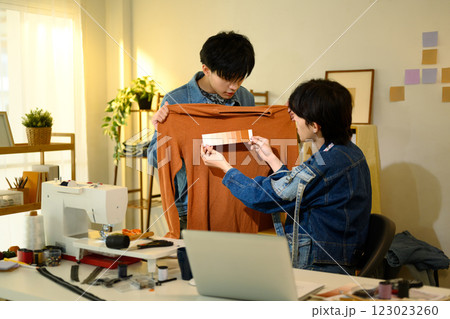 Team of designers selecting colors for clothing design in a creative studio Team of designers selecting colors for clothing design in a creative studio 123023260