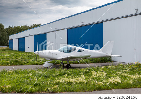 White small sports airplane at the aviation hangars White small sports airplane at the aviation hangars 123024168