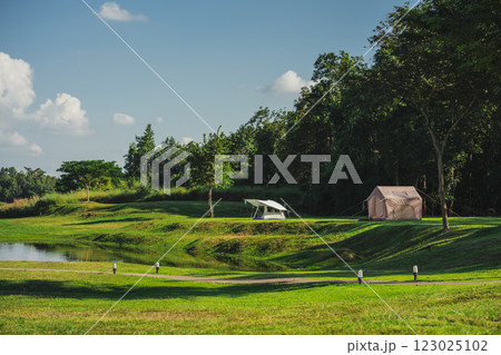 travel and people activity concept with camping on grass  with mountain and lake on foreground 123025102