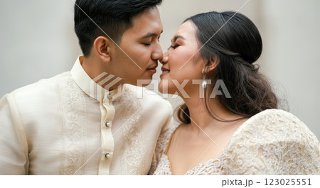 Romantic moment between young asian couple in traditional wedding attire 123025551