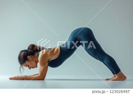 Yoga poses for strength and flexibility studio setting fitness photography bright minimalist environment side view mind-body connection 123026497