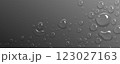 Water droplets scatter on smooth gray surface. 123027163