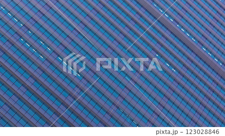 A repetitive glass facade creates a mesmerizing geometric pattern. The diagonal angle enhances depth and visual rhythm. 123028846