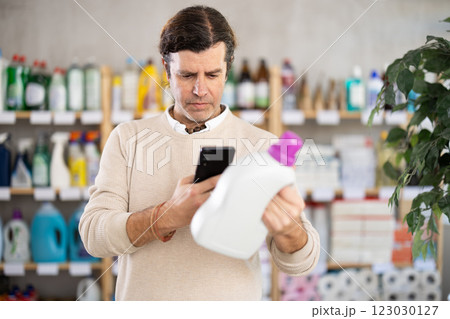 Man scanning barcode of cleansers Man scanning barcode of cleansers 123030127