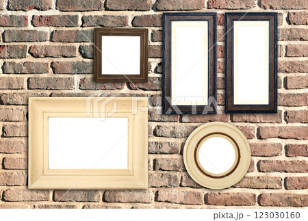 Horizontal banner with blank picture frames hanging on brick wall. Empty photo frame set on wall background. Mock up poster frame template for decor room. Retro Interior design. Copy space for text 123030160