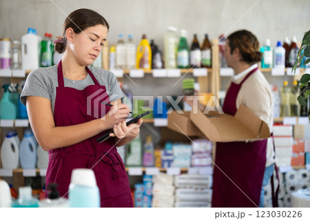 Female household goods store worker using tablet to manage inventory 123030226