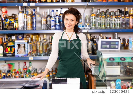 Adult saleswoman posing at store counter 123030422