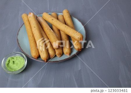 Sausage meat products on a plate on a gray background with space for text Copyspace side view. The concept of homemade sausages 123033481