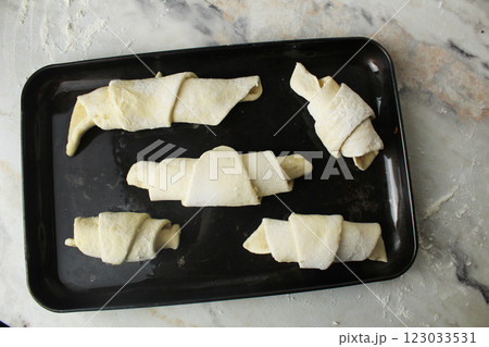 Close-up of raw croissant on a baking sheet top view 123033531