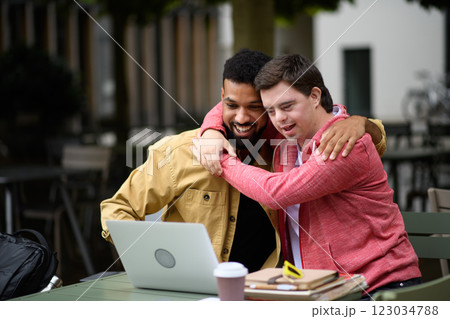 Young man with Down syndrome hugging his special educator teacher. Young man with Down syndrome hugging his special educator teacher. 123034788