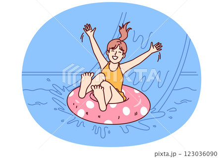 Little girl in pool floats on inflatable ring and enjoys visiting aqua park in sunny summer weather 123036090