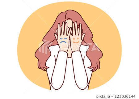 Faces with different moods are depicted on hands of woman hiding face for concept bipolar disorder Faces with different moods are depicted on hands of woman hiding face for concept bipolar disorder 123036144