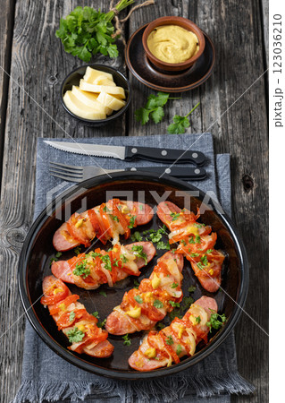 hot sausages baked with cheese, tomato, mustard 123036210
