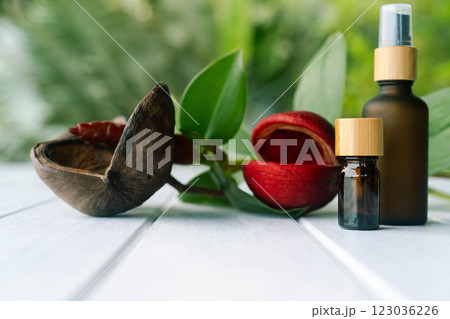 Green background showcases stylish cosmetic bottles alongside natural elements and flowers. Green background showcases stylish cosmetic bottles alongside natural elements and flowers. 123036226