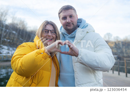 Happy family spend time together, parents making heart or love gesture with hands. Family vacation concept Happy family spend time together, parents making heart or love gesture with hands. Family vacation concept 123036454
