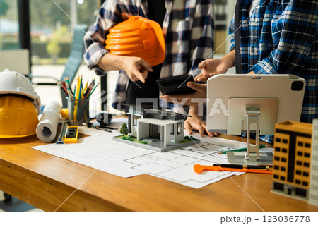 civil engineer or architect business useing calculator about calculate the cost with for working building plan design project in office. civil engineer or architect business useing calculator about calculate the cost with for working building plan design project in office. 123036778