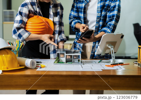 civil engineer or architect business useing calculator about calculate the cost with for working building plan design project in office. 123036779