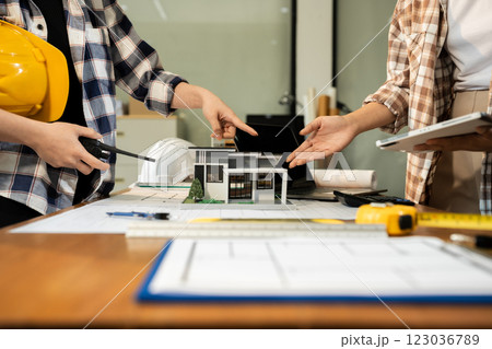 brainstorming and measuring for cost estimating on paperworks and floor plan drawings about design architectural and engineering for houses and buildings. 123036789