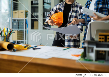 Engineer teams meeting working together wear worker helmets hardhat on construction site in modern city.Asian industry professional team. 123036800