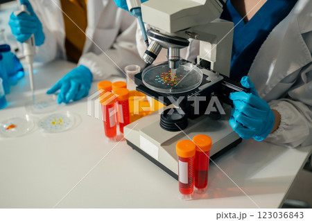 Lab work, Doctor holds a test tube takes the test from a test tube in analysis, blood, DNA, test tube stand. 123036843