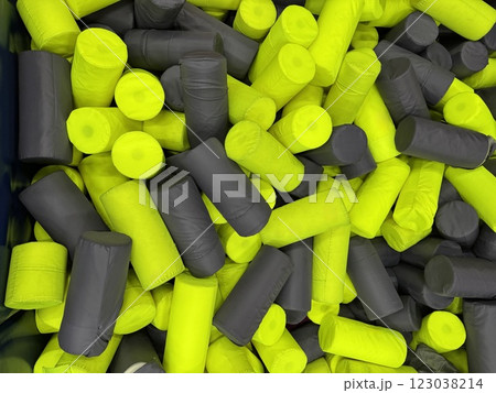 Foam cylinder jumping pit background. Funny kids playing zone with soft covered blocks. Foam cylinder jumping pit background. Funny kids playing zone with soft covered blocks. 123038214