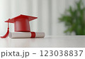 Graduation cap and diploma on white table with blurred green background 123038837