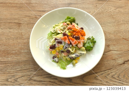 crab stick and vegetable topping shrimp egg salad on plate 123039413