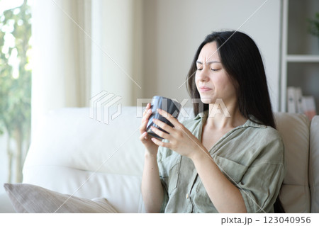 Asian woman complaining about coffee bad taste Asian woman complaining about coffee bad taste 123040956