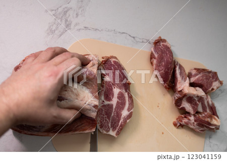 Freshly Cut Pork Meat Placed on a Chopping Board Ready for Preparation and Cooking Freshly Cut Pork Meat Placed on a Chopping Board Ready for Preparation and Cooking 123041159