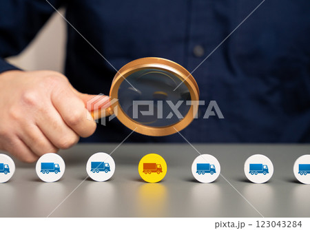 An official examines a truck in a freight stream. Economic assessment. Customs control. Import and export control. Logistics, taxation. Customs duties, freight inspection. Border security. An official examines a truck in a freight stream. Economic assessment. Customs control. Import and export control. Logistics, taxation. Customs duties, freight inspection. Border security. 123043284