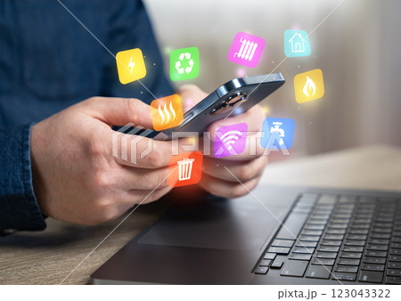 The man pays household bills for services and utilities via phone or internet. Online payment. Electricity, water, garbage collection, internet. Expenses, budgeting, and cost of living. The man pays household bills for services and utilities via phone or internet. Online payment. Electricity, water, garbage collection, internet. Expenses, budgeting, and cost of living. 123043322