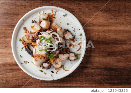 Stir-fried octopus on a White Plate. 123043836