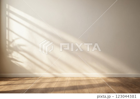 Minimalistic light background with blurred foliage shadow on white wall 123044381