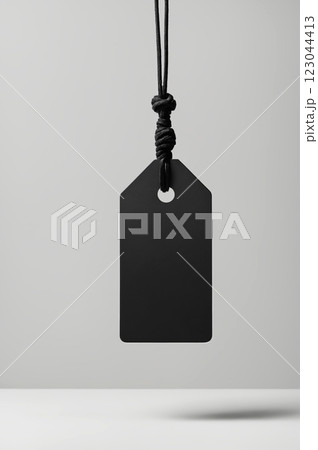 Blank empty mockup of tag label on rope. paper black tag label or sticker 123044413