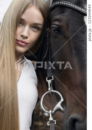 beautiful blond young woman with horse beautiful blond young woman with horse 123044644