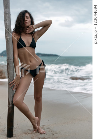 Beautiful young woman on beach. pretty Sexy girl in Bikini near sea 123044694