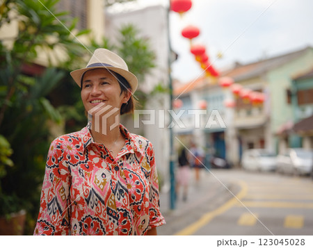 woman exploring streets of George Town, during Chinese New Year. 123045028