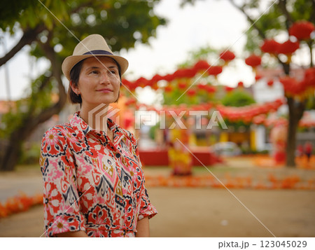 woman exploring streets of George Town, during Chinese New Year. 123045029