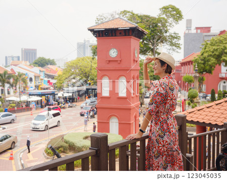 woman in dress and hat exploring vibrant streets of Malacca, Malaysia. 123045035