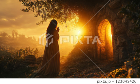 Mary magdalene at jesus christ's tomb with new covenant and resurrection faith in beautiful sunrise scene for spiritual inspiration 123045426
