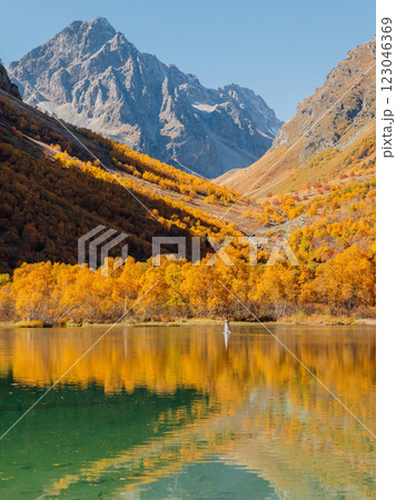 Mountain lake with glassy surface on water and autumnal trees. 123046369
