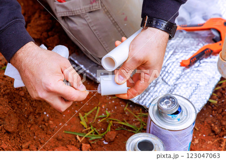 Individual work service on plumbing project using pipes, tools for water line installation 123047063