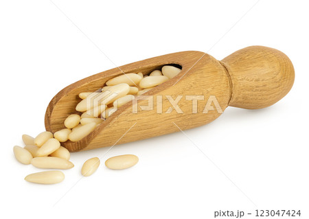 Shelled European pine nuts in wooden scoop isolated on white background with full depth of field 123047424