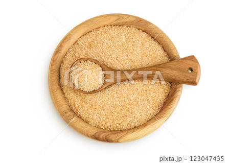 The brown sugar in wooden bowl isolated on white background. Top view. Flat lay The brown sugar in wooden bowl isolated on white background. Top view. Flat lay 123047435