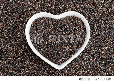 black quinoa in ceramic bowl as a background. Top view. Flat lay 123047456