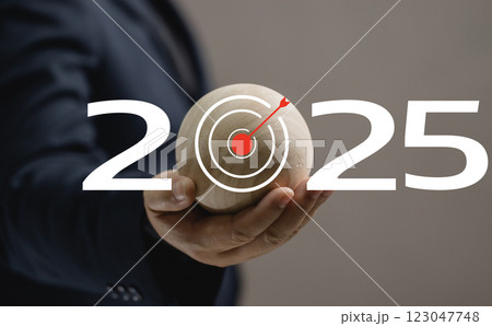 man hold the marketing 2025 icon in hand. business target for success strategy and goal. achievement competition idea growth. aspiration, challenge, performance, arrow, solution, aim, leadership. 123047748