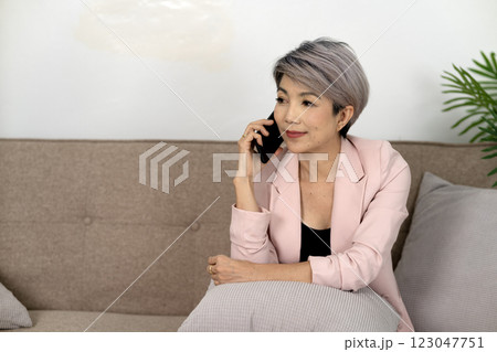 female executive is comfortable and happy using the phone female executive is comfortable and happy using the phone 123047751